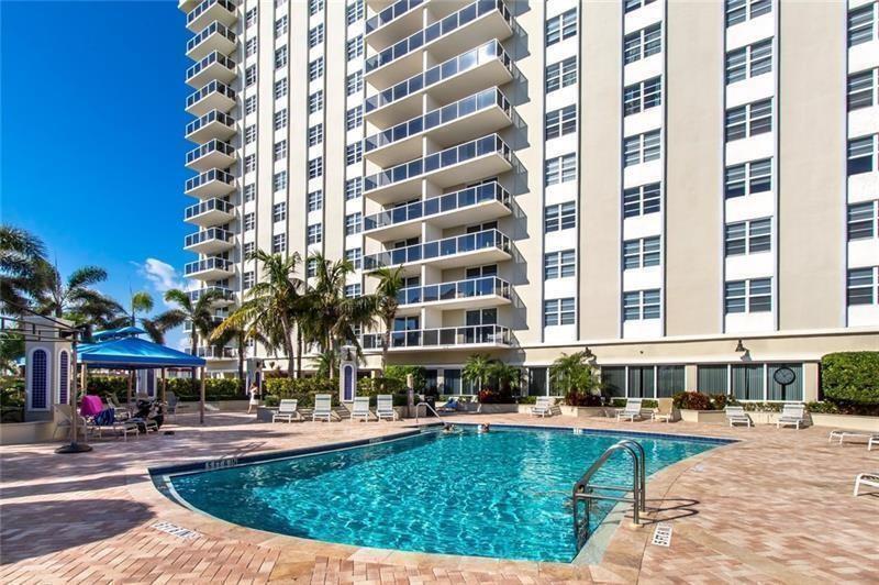 336 North Birch Road, Unit 8D Fort Lauderdale, FL 33304 - Photo 3 of 23 a view of a swimming pool with a lounge chairs