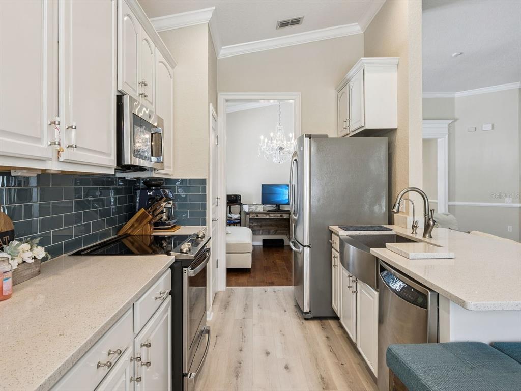 13403 Riggs Way Windermere, FL 34786 - Photo 15 of 47 a kitchen with a sink stove and refrigerator