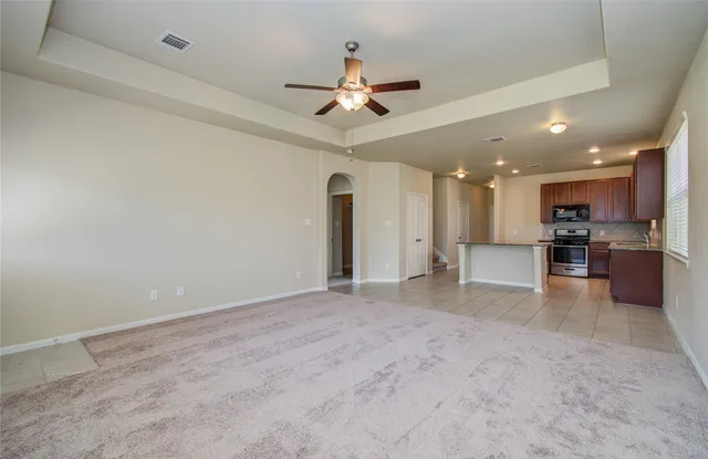 a view of kitchen with a sink stainless steel appliances and cabinets