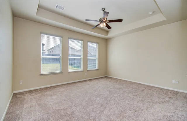 a spacious bathroom with a granite countertop sink a mirror and a bathtub