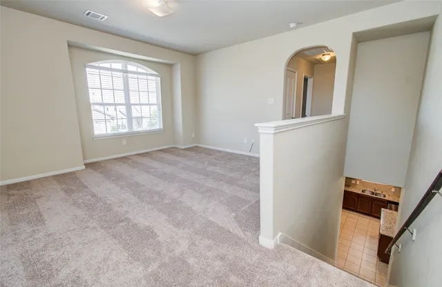an empty room with windows and closet