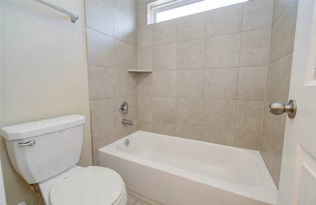 a view of an house with backyard and a patio