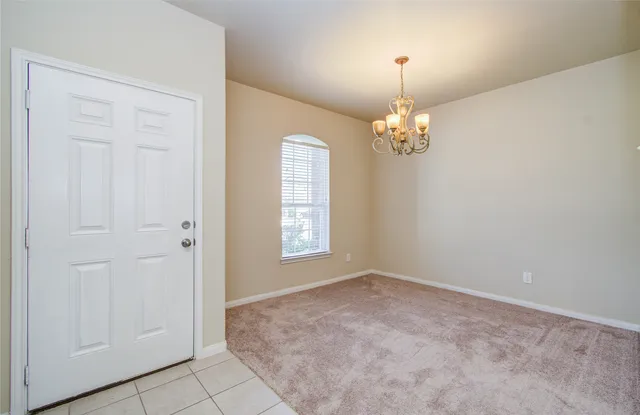 a view of an empty room with a chandelier