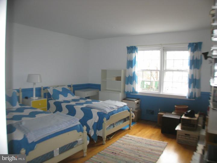 340 Jefferson Road Princeton, NJ 08540 - Photo 9 of 12 a bedroom with a bed and wooden floor