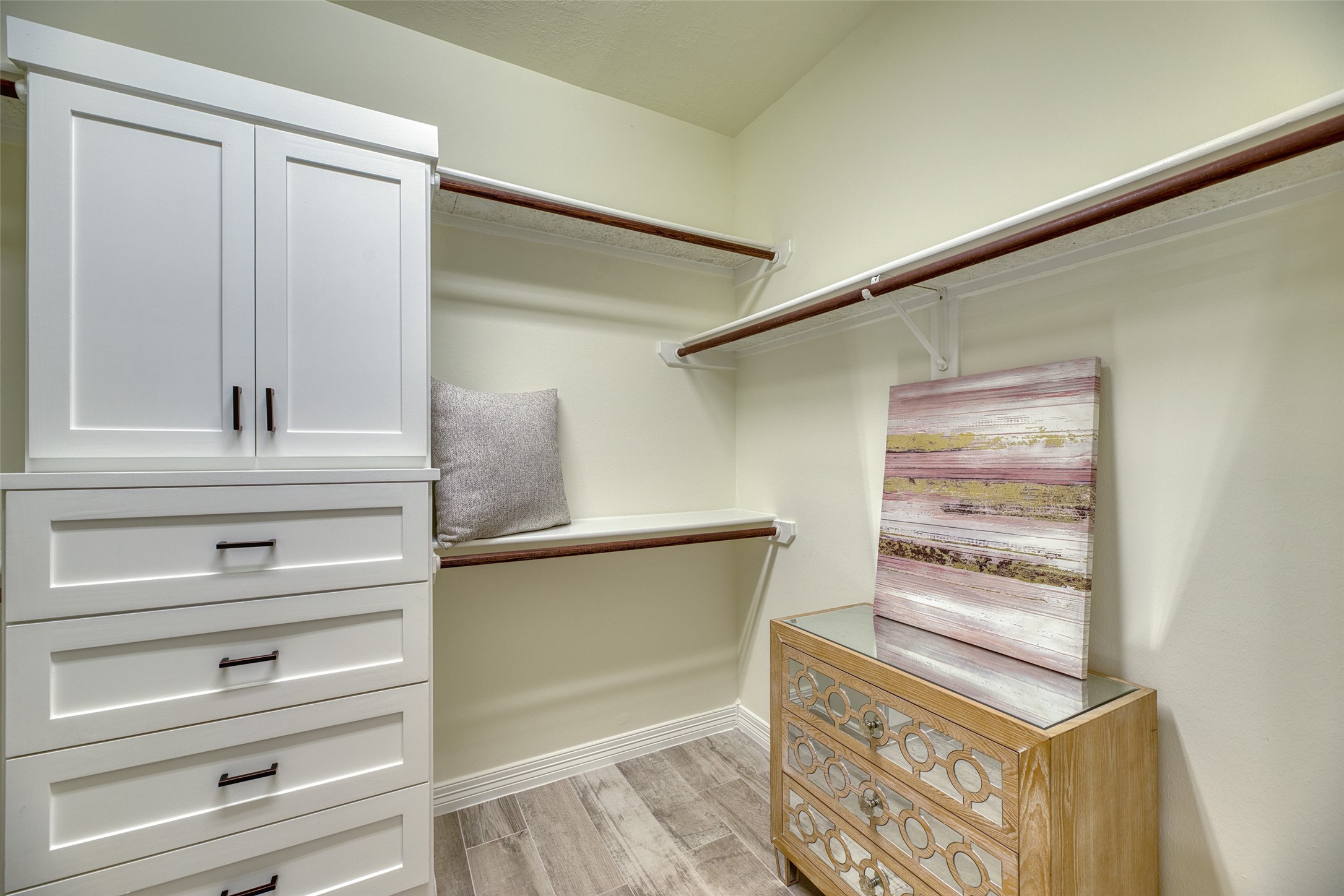 911 Chisel Point Drive Houston, TX 77094 - Photo 25 of 50 Expansive walk-in closet featuring built-in drawers, shelving, and dual hanging rods. Designed for both storage and organization.