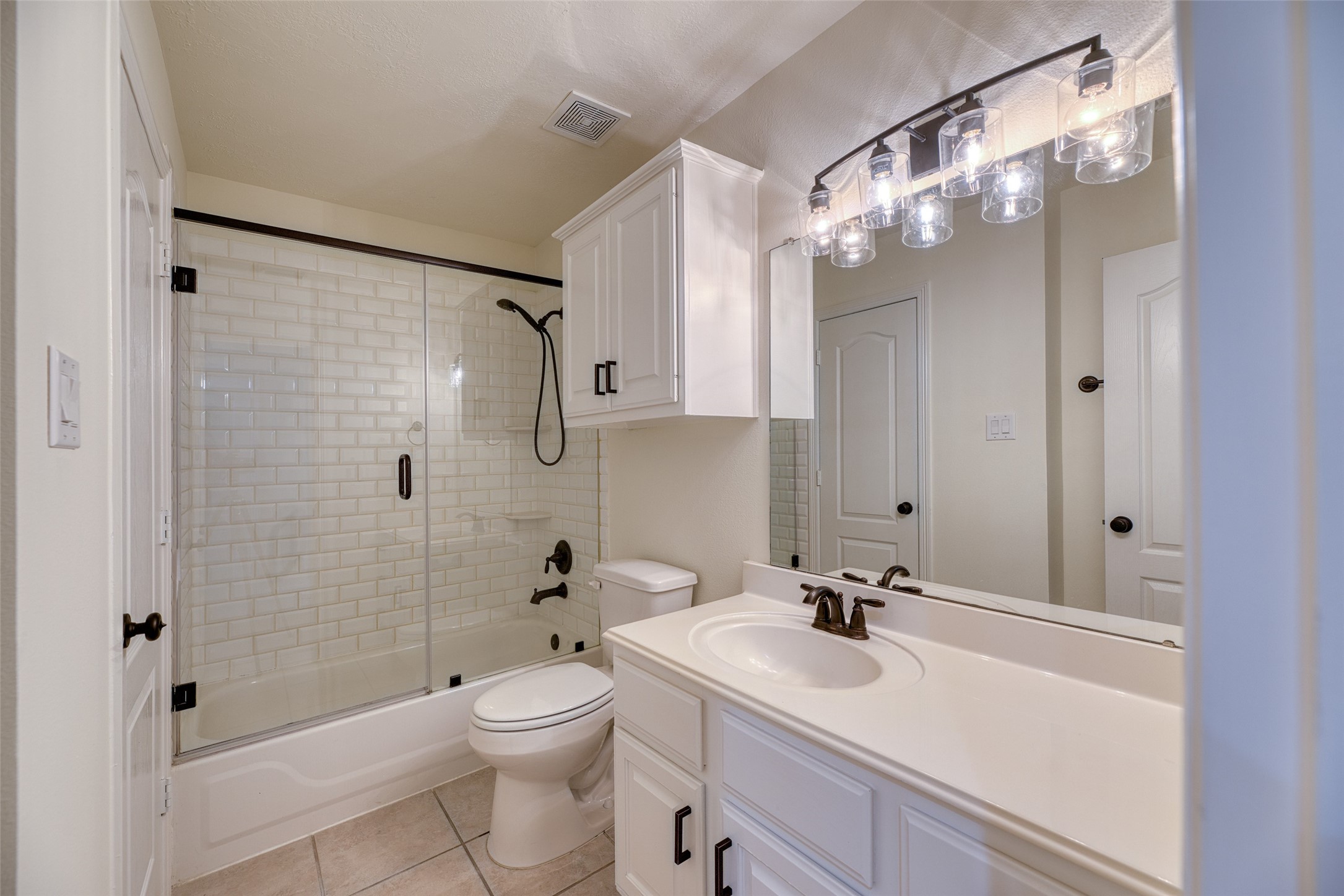 911 Chisel Point Drive Houston, TX 77094 - Photo 28 of 50 Updated full bath with white cabinetry, subway tile tub/shower combo, and oil-rubbed bronze fixtures.