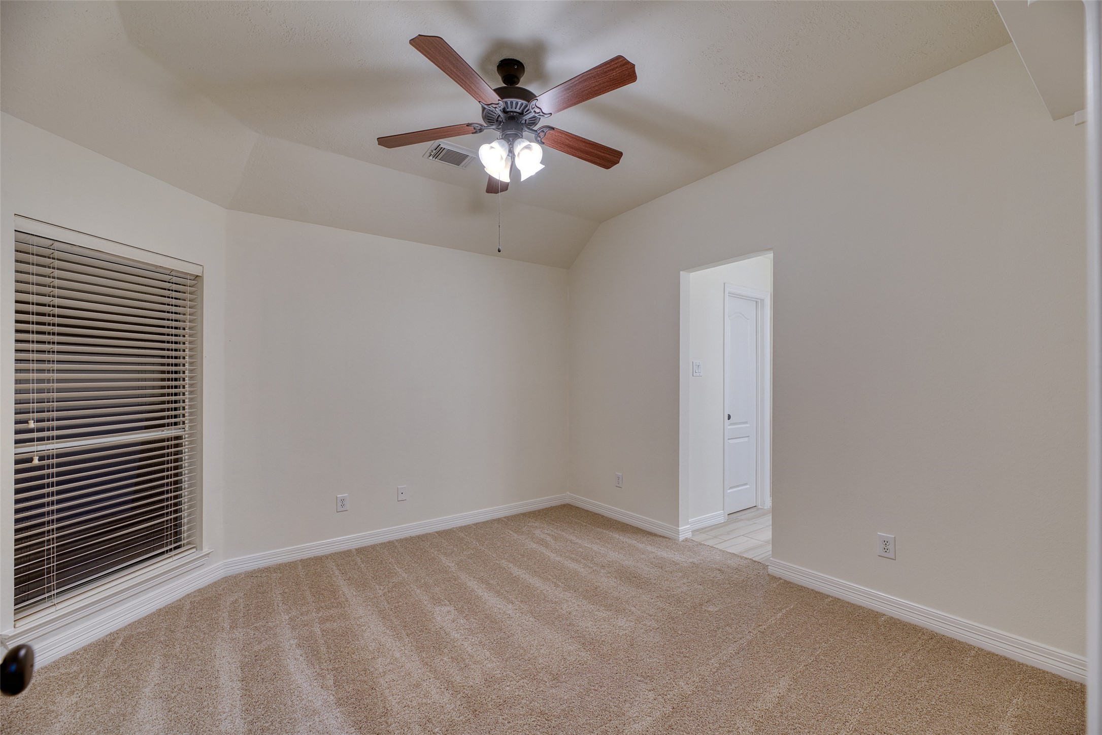 911 Chisel Point Drive Houston, TX 77094 - Photo 29 of 50 Bright and spacious bedroom with ceiling fan, plush carpet, and large window for natural light.