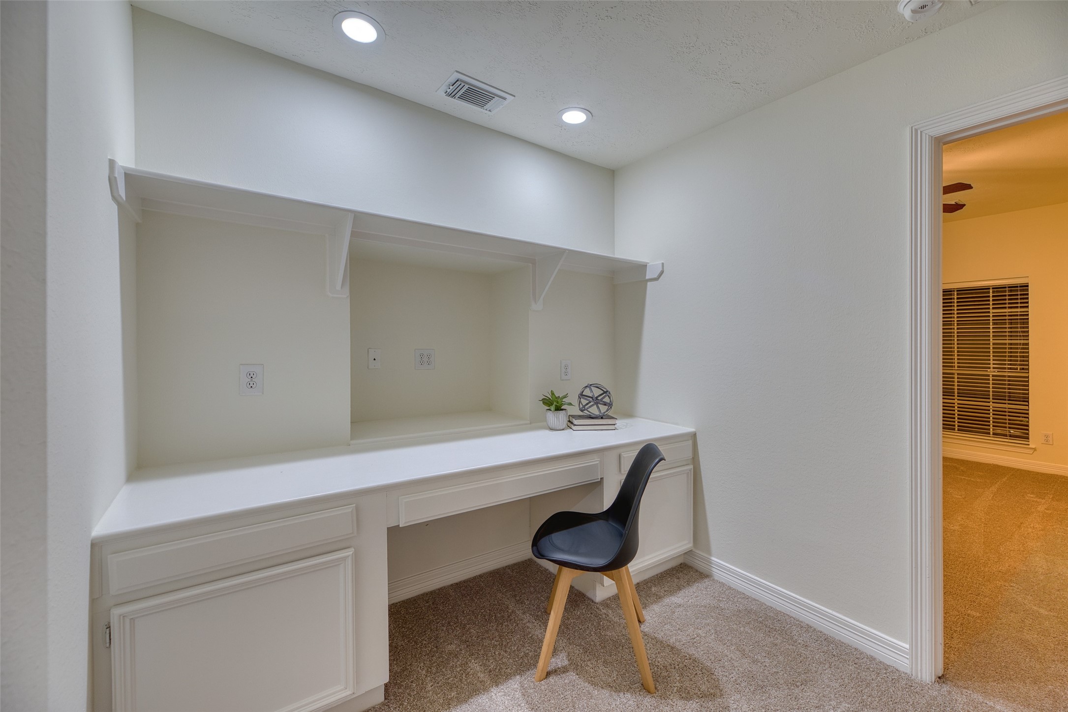 911 Chisel Point Drive Houston, TX 77094 - Photo 33 of 50 Convenient built-in study desk with shelving and recessed lighting, ideal for a homework station or home office.