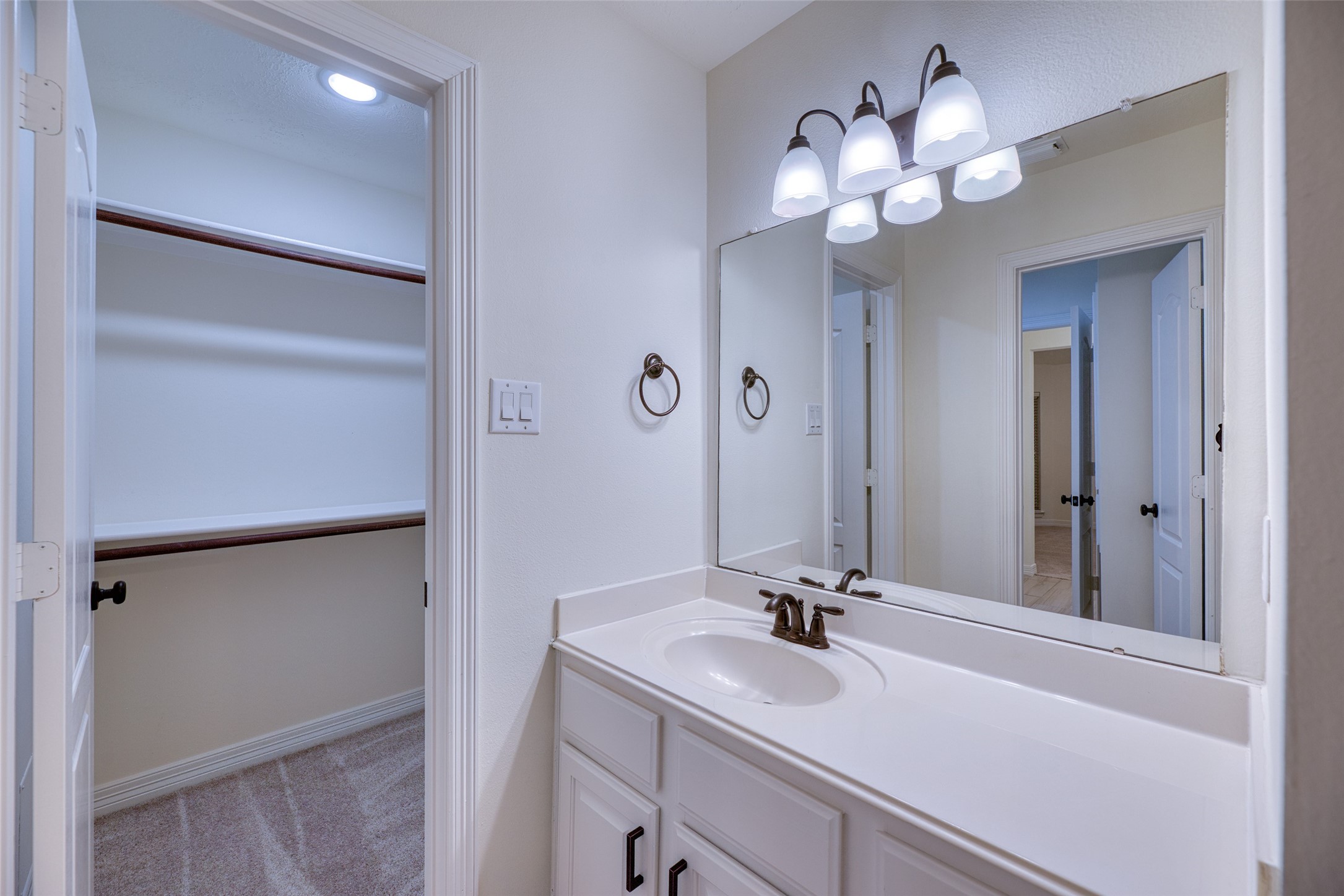 911 Chisel Point Drive Houston, TX 77094 - Photo 35 of 50 Private vanity space with updated lighting, oil-rubbed bronze fixtures, and direct access to a walk-in closet.