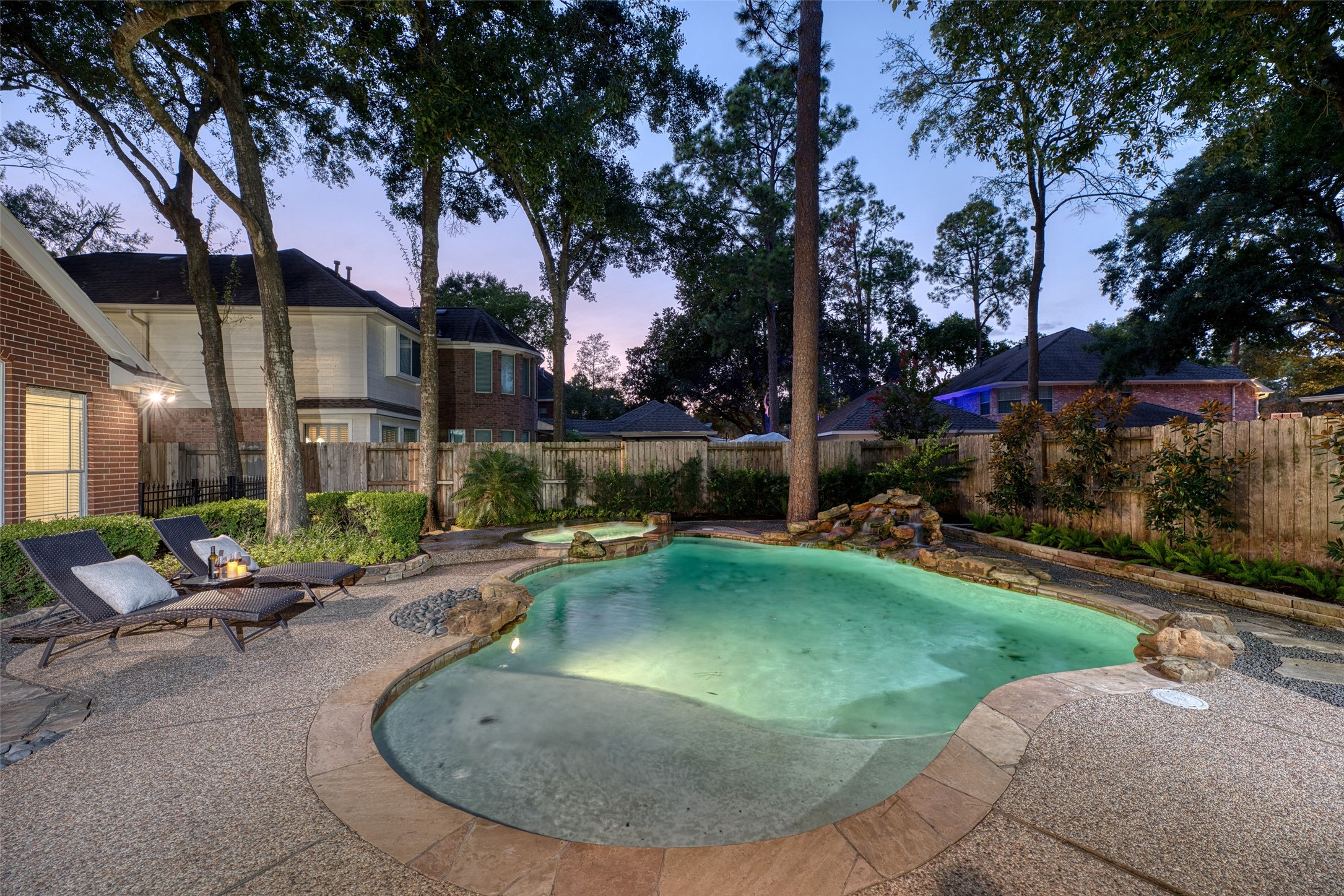 911 Chisel Point Drive Houston, TX 77094 - Photo 43 of 50 A sparkling pool takes center stage in the private backyard, surrounded by a spacious patio perfect for lounging or entertaining. The backdrop of mature trees adds privacy and a resort-style atmosphere.