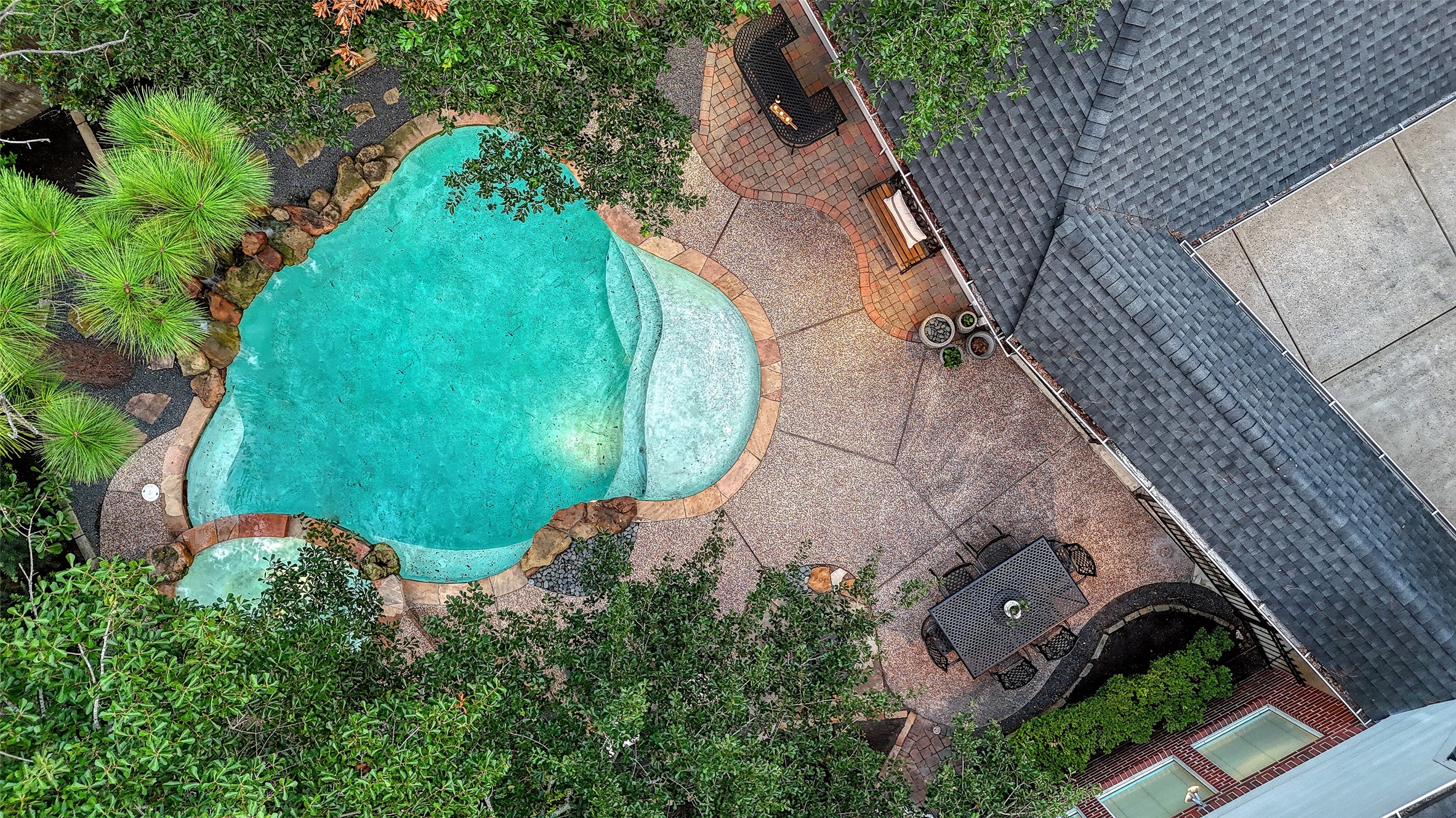 911 Chisel Point Drive Houston, TX 77094 - Photo 5 of 50 Bird’s-eye view capturing the home, expansive driveway, and lushly landscaped backyard complete with a resort-style pool, spa, and multiple entertaining spaces.
