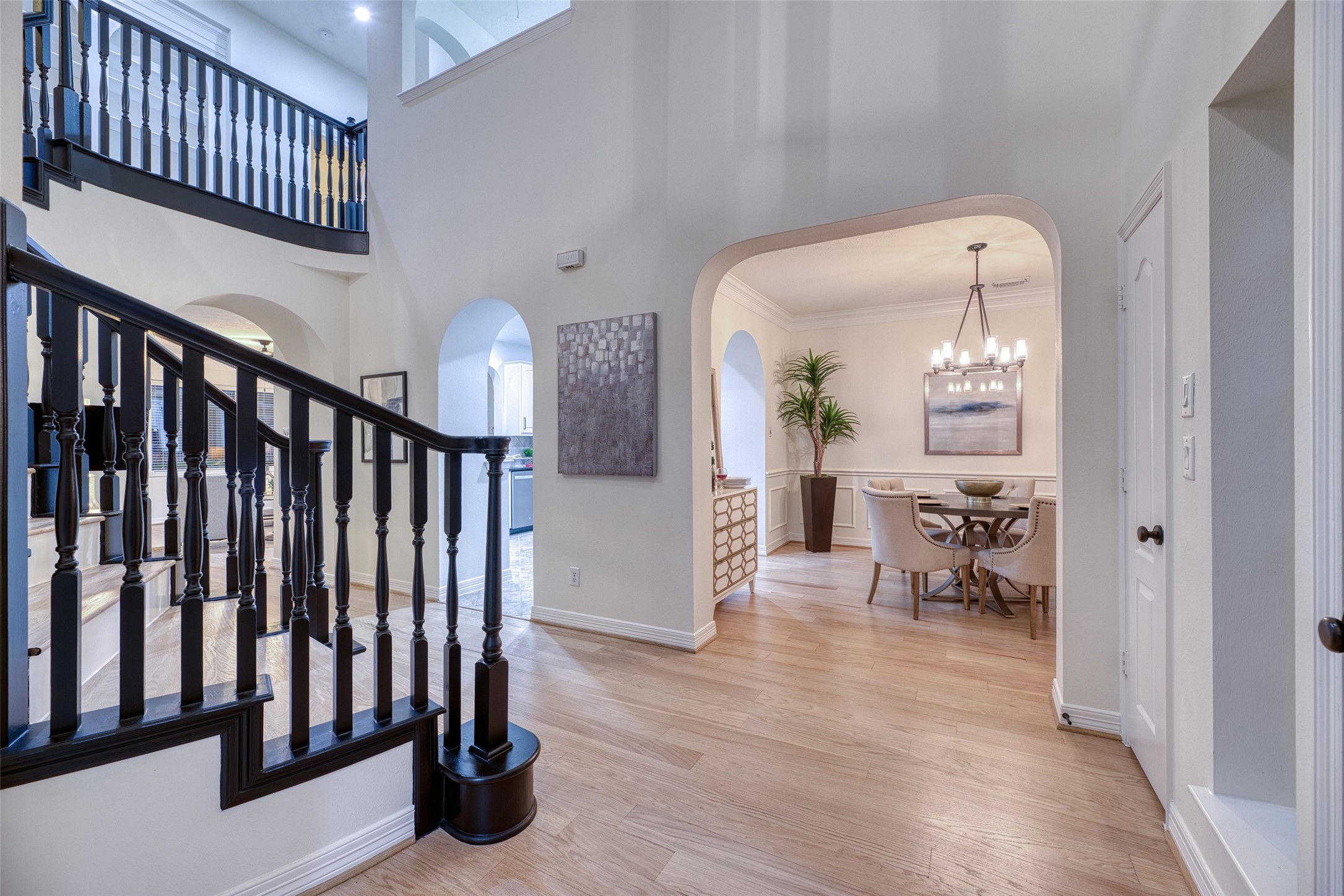 911 Chisel Point Drive Houston, TX 77094 - Photo 6 of 50 Inviting foyer with soaring ceilings, elegant staircase, and views into the formal dining room. Natural light highlights the open layout and hardwood floors.