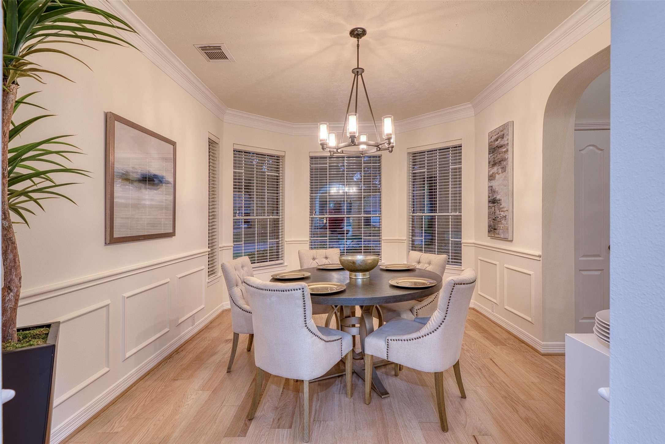 911 Chisel Point Drive Houston, TX 77094 - Photo 8 of 50 Elegant dining room with bay windows, detailed wainscoting, and a modern chandelier. Perfect for formal meals or intimate gatherings.