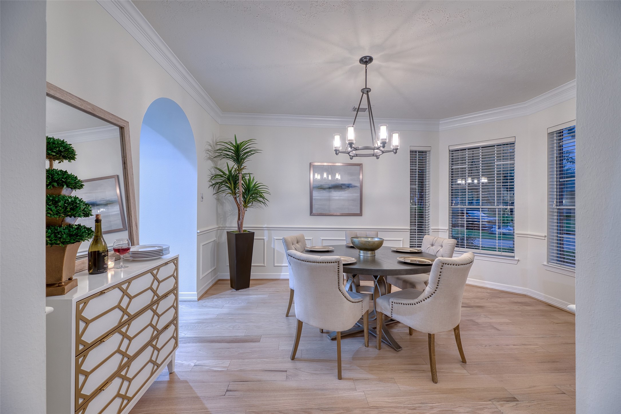 911 Chisel Point Drive Houston, TX 77094 - Photo 9 of 50 Elegant dining room featuring bay windows, chandelier, and convenient access to serving area. Classic finishes and neutral tones offer a timeless look.