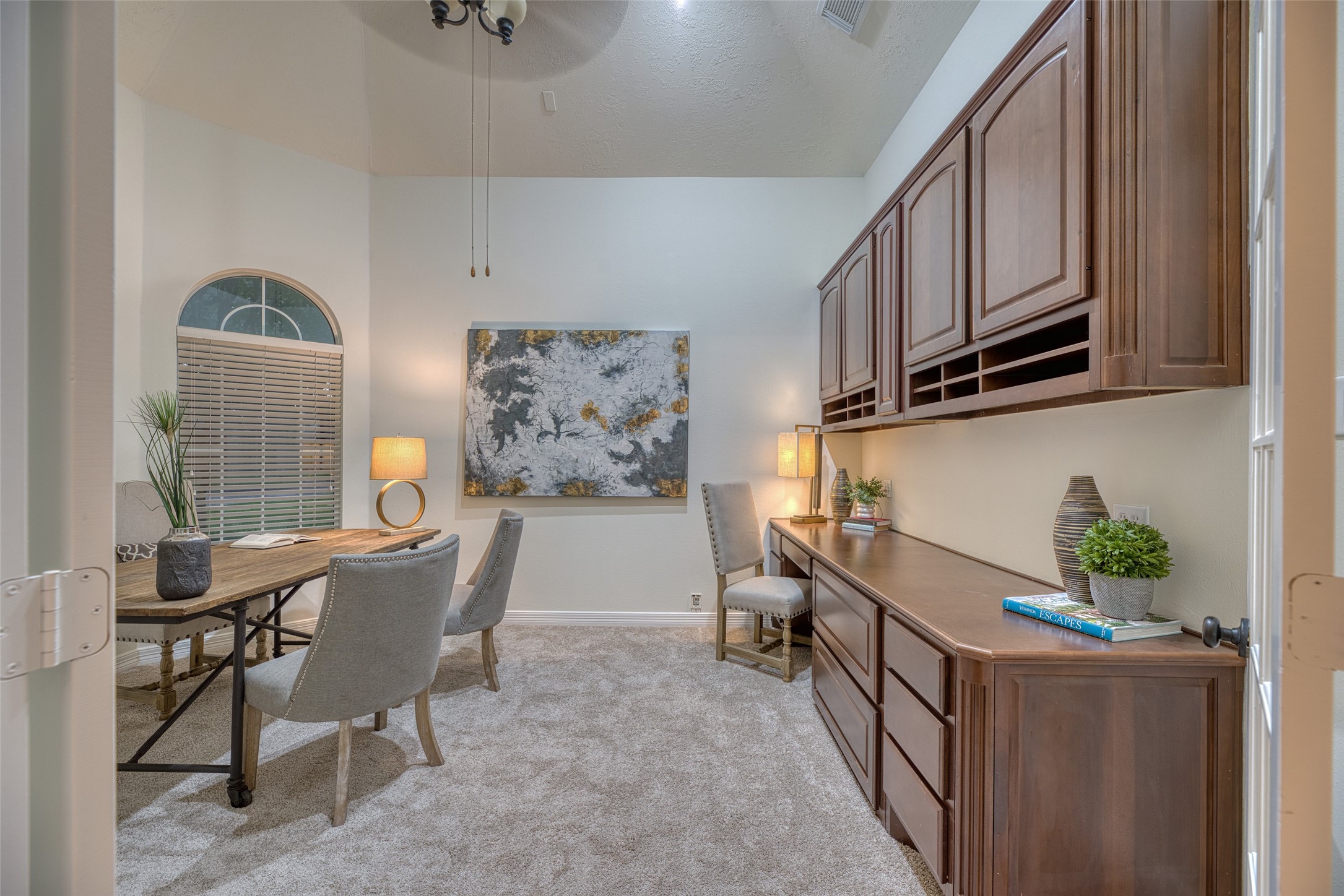 911 Chisel Point Drive Houston, TX 77094 - Photo 10 of 50 Bright home office with built-in cabinetry and expansive workspace. Neutral tones and plush carpet offer a warm, professional feel.