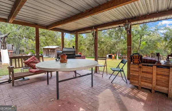 a view of a patio with a table chairs and a table