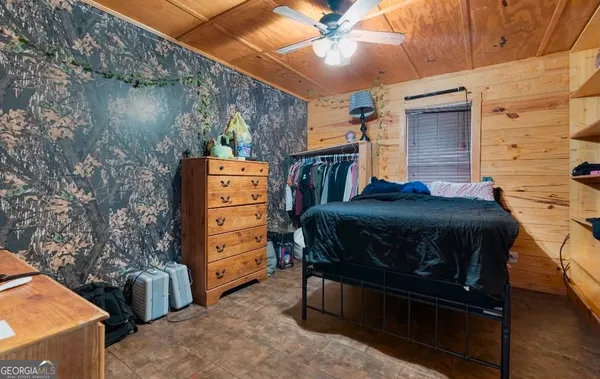 a bedroom with a bed and a mirror