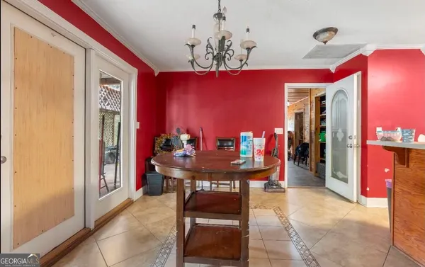 a view of a dining room with furniture and chandelier