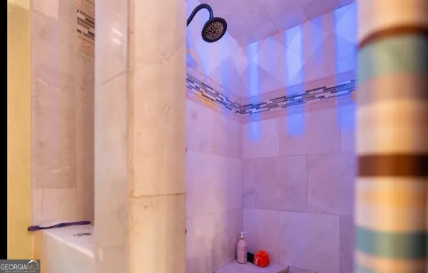 a bathroom with a shower curtain and a window