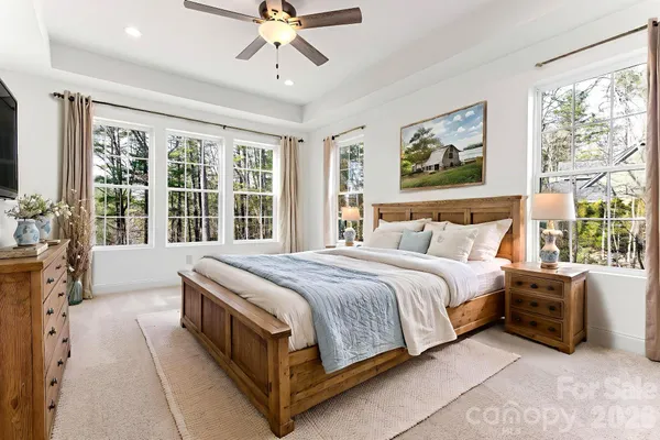a spacious bedroom with a large bed and a window