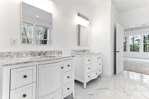 a bathroom with a granite countertop sink mirror and
