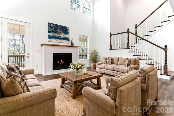 a living room with furniture fireplace and a window