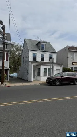 a couple of cars parked in front of a house