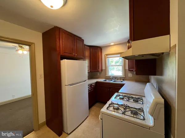 a kitchen with a refrigerator and a stove