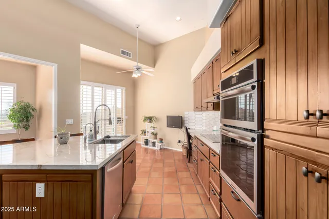 a kitchen with a sink stove and cabinets