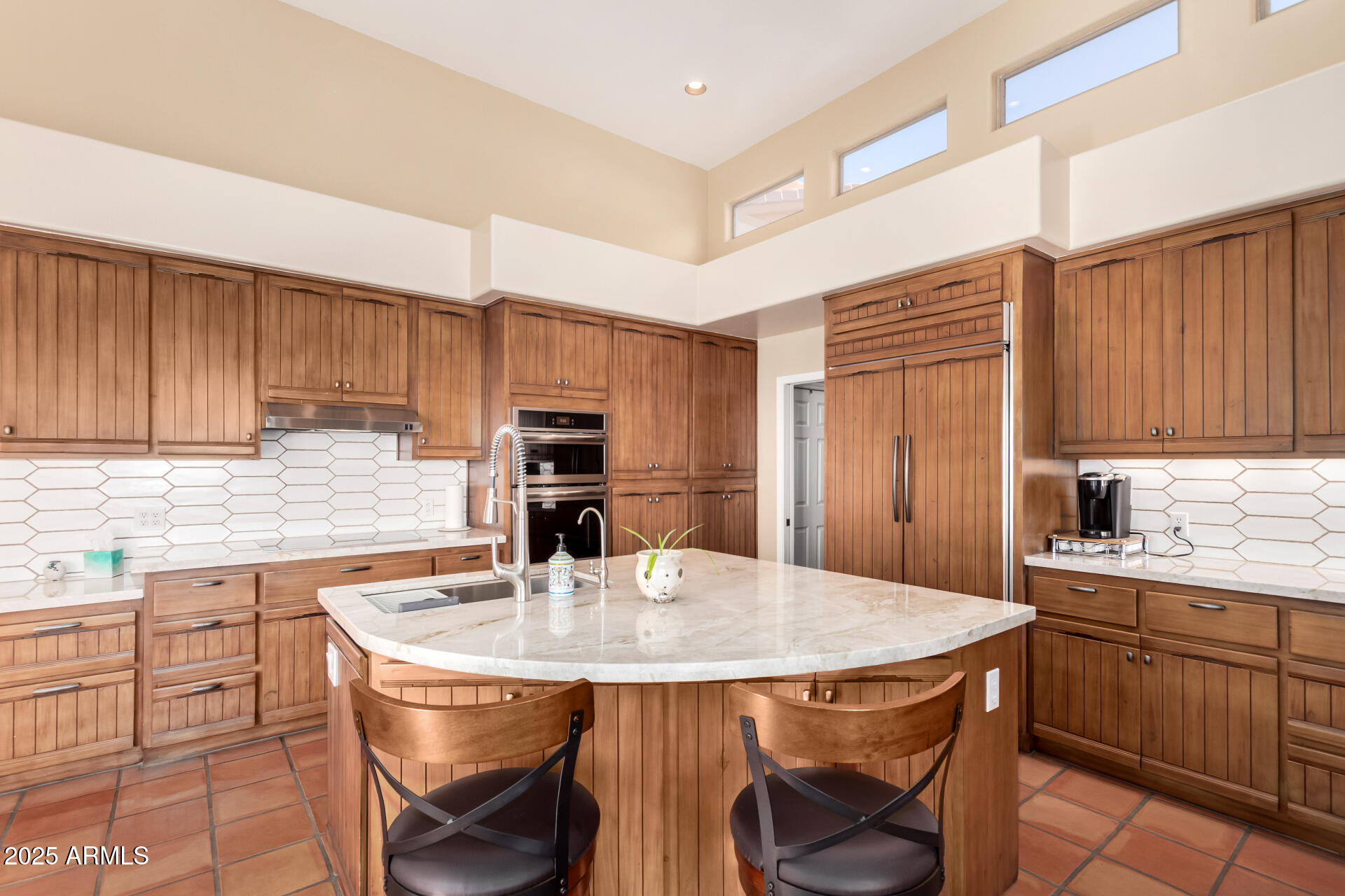 31 West Beryl Avenue Phoenix, AZ 85021 - Photo 15 of 65 a kitchen with stainless steel appliances a kitchen island a table and chairs in it