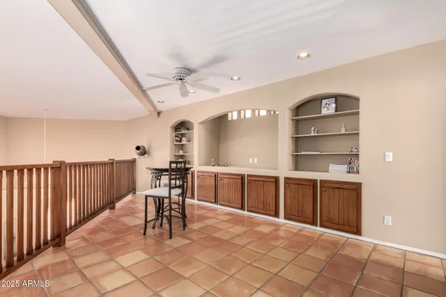 a dining hall with a large window and chandelier