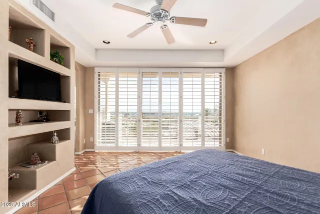 a white bath tub sitting in a bathroom next to a window