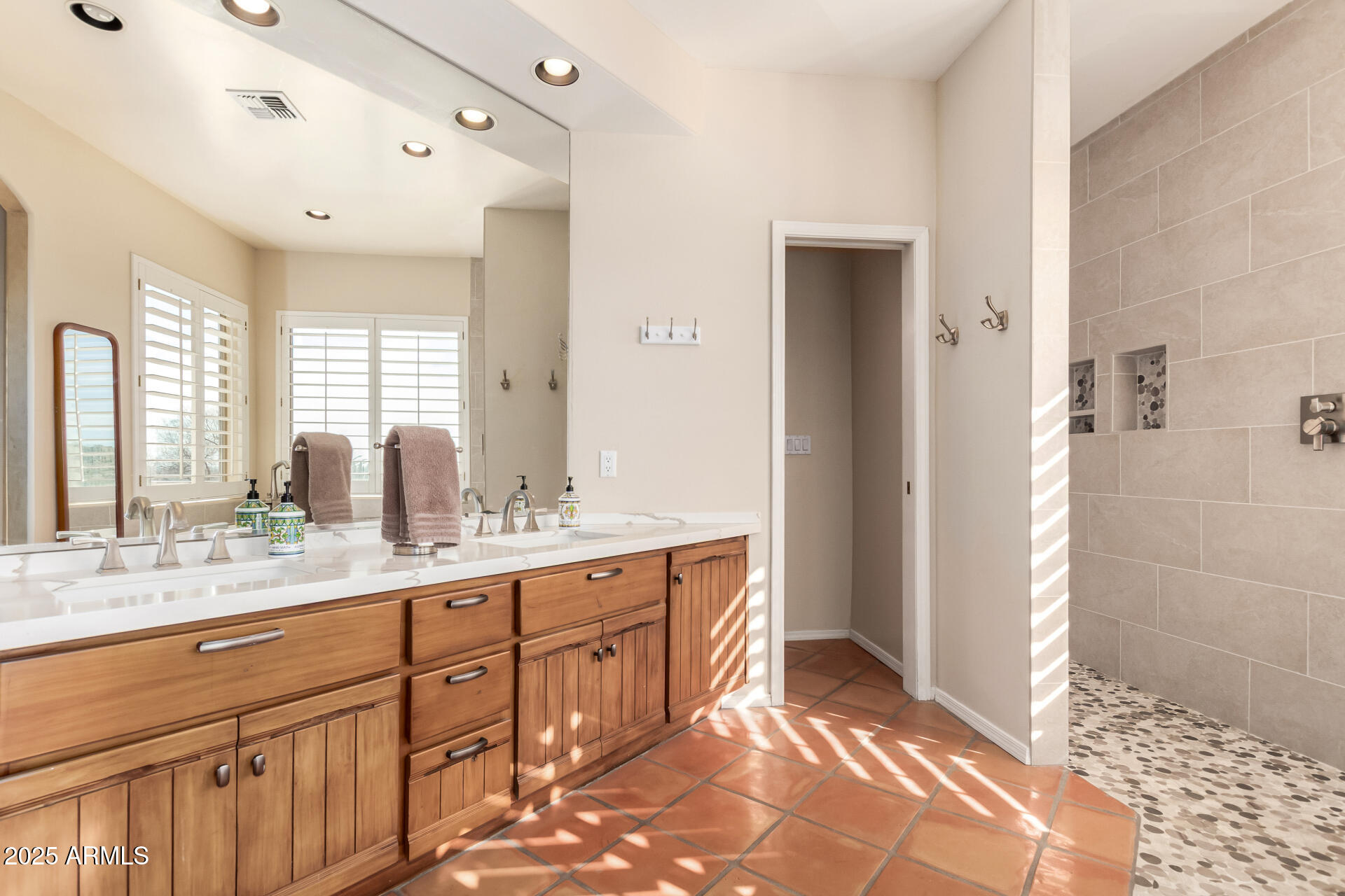 31 West Beryl Avenue Phoenix, AZ 85021 - Photo 25 of 65 a spacious bathroom with a double vanity sink a mirror and a shower