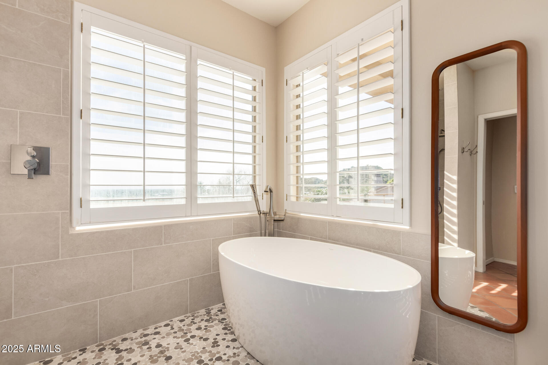 31 West Beryl Avenue Phoenix, AZ 85021 - Photo 27 of 65 a white bath tub sitting in a bathroom next to a window