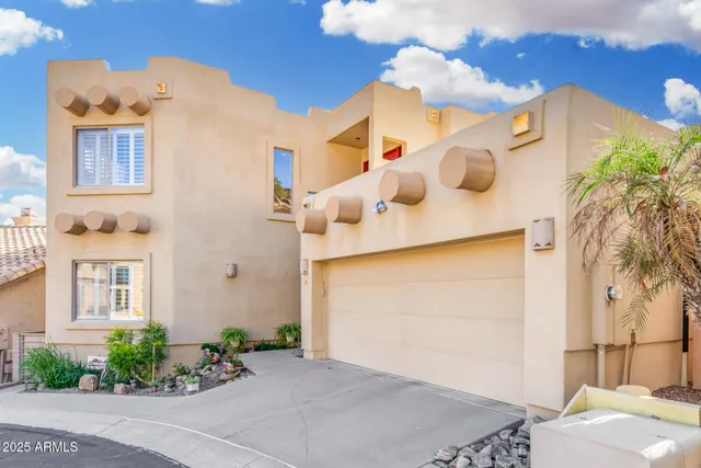 a front view of a house with plants