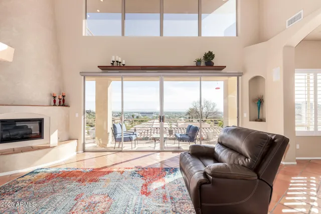a living room with furniture and a floor to ceiling window