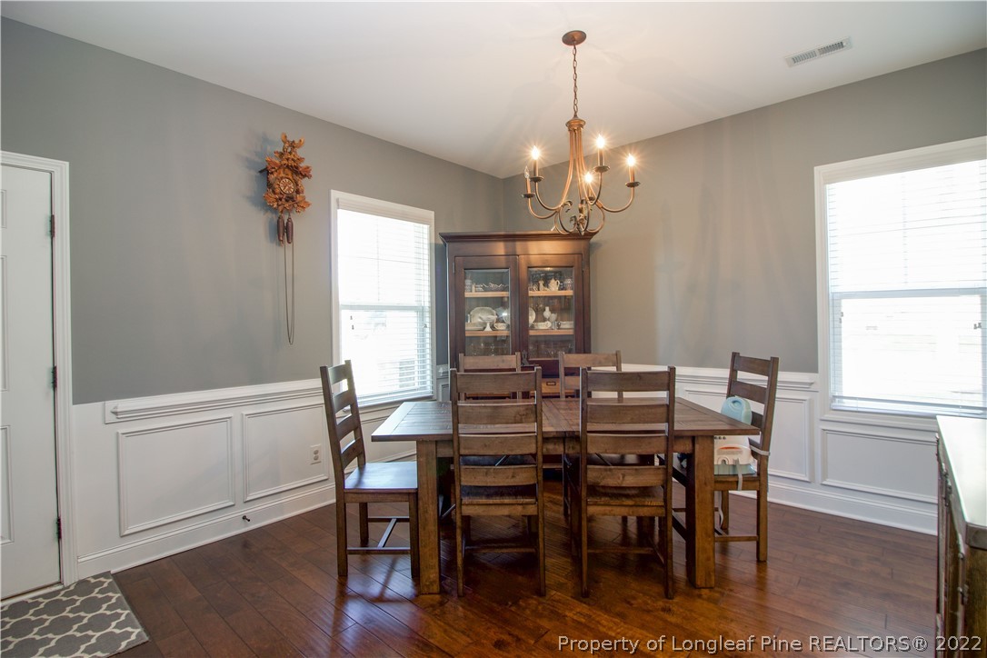202 Sandy Springs Road Aberdeen, NC 28315 - Photo 11 of 44 a view of a dining room with furniture window and wooden floor