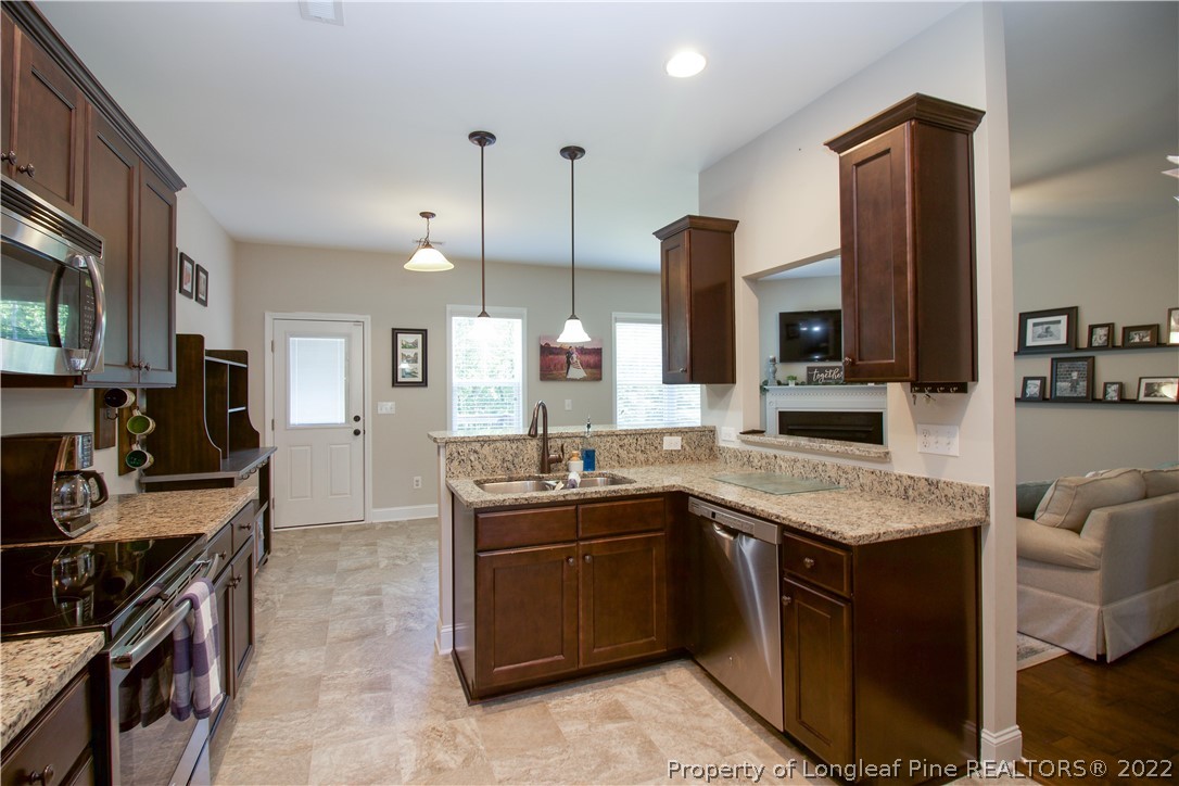 202 Sandy Springs Road Aberdeen, NC 28315 - Photo 17 of 44 a kitchen with a sink stove and microwave