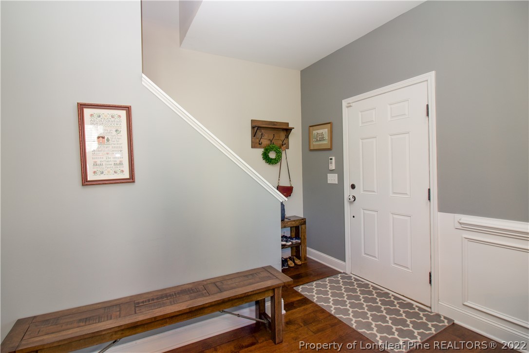 202 Sandy Springs Road Aberdeen, NC 28315 - Photo 2 of 44 a room with stairs and paintings on the wall