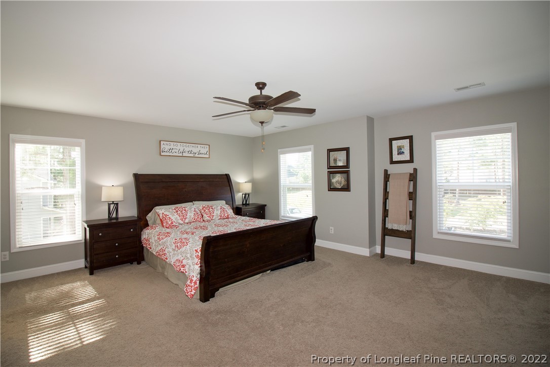 202 Sandy Springs Road Aberdeen, NC 28315 - Photo 22 of 44 a spacious bedroom with a bed and a window
