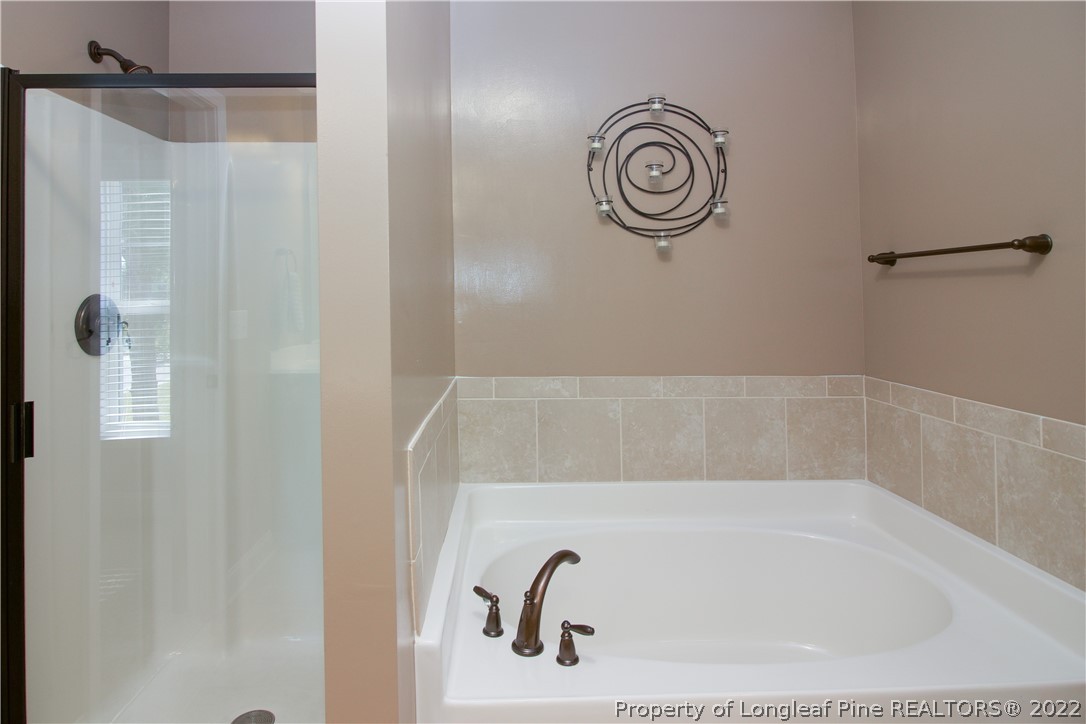 202 Sandy Springs Road Aberdeen, NC 28315 - Photo 24 of 44 a bathroom with a bathtub and shower