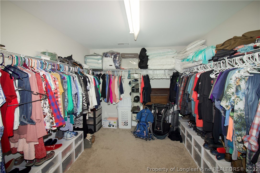 202 Sandy Springs Road Aberdeen, NC 28315 - Photo 26 of 44 a view of walk in closet with clothes