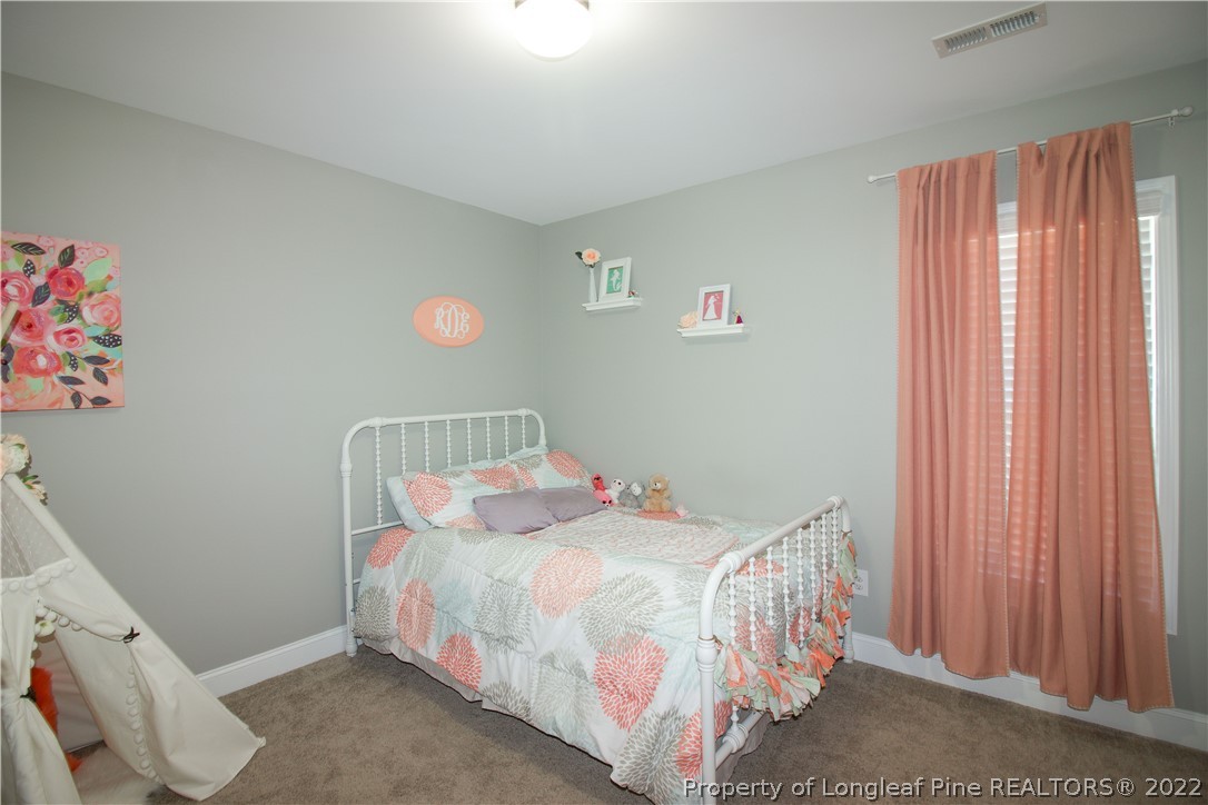 202 Sandy Springs Road Aberdeen, NC 28315 - Photo 27 of 44 a bedroom with a bed and a window