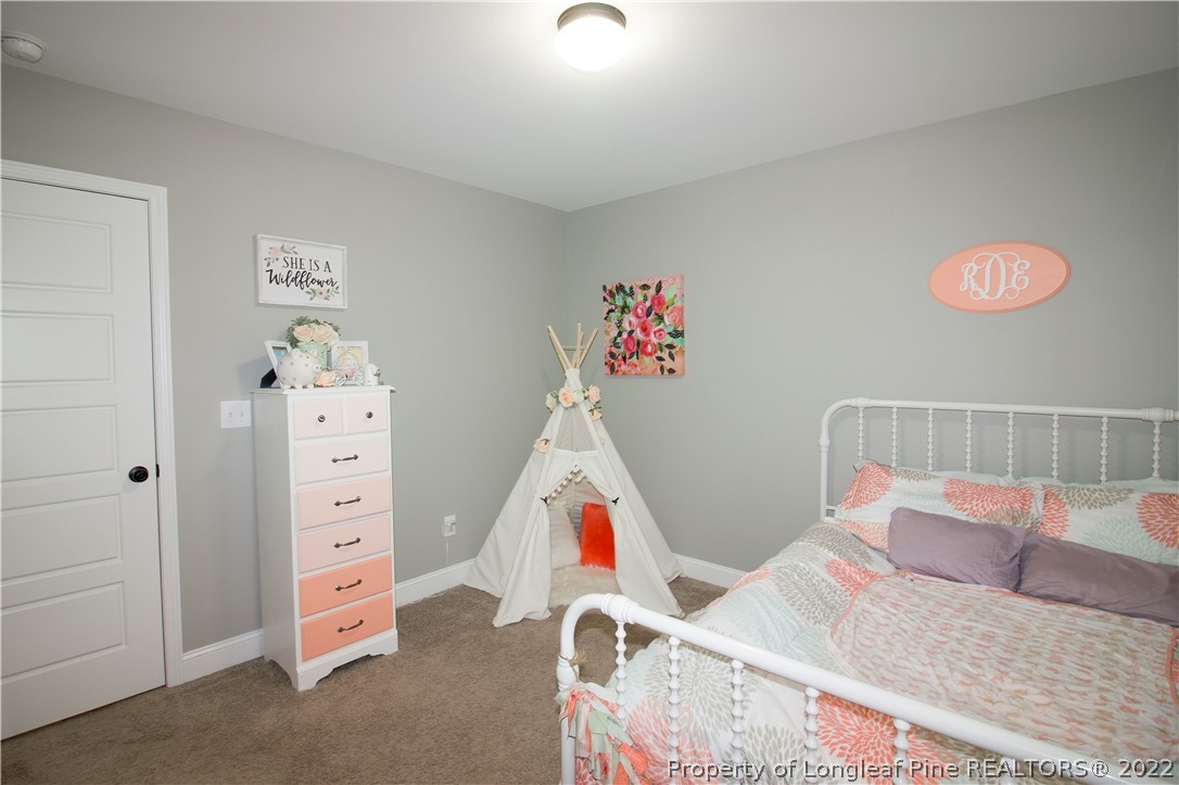 202 Sandy Springs Road Aberdeen, NC 28315 - Photo 28 of 44 a bedroom with furniture and a wooden floor