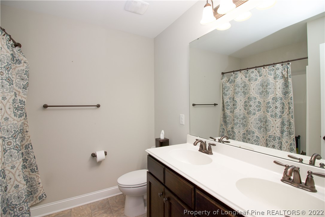 202 Sandy Springs Road Aberdeen, NC 28315 - Photo 29 of 44 a bathroom with a sink and a mirror
