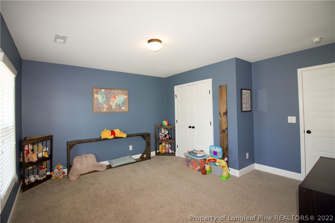 202 Sandy Springs Road Aberdeen, NC 28315 - Photo 33 of 44 a children room with toys and a couch