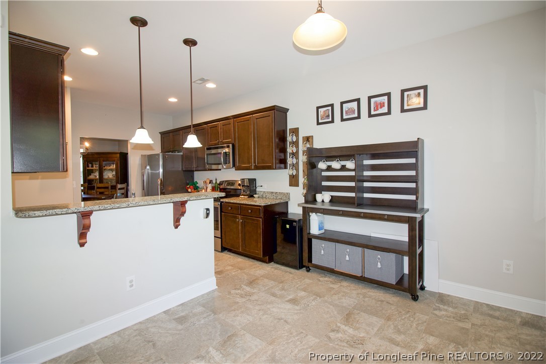 202 Sandy Springs Road Aberdeen, NC 28315 - Photo 10 of 44 a kitchen with stainless steel appliances granite countertop a refrigerator a oven a sink and a stove