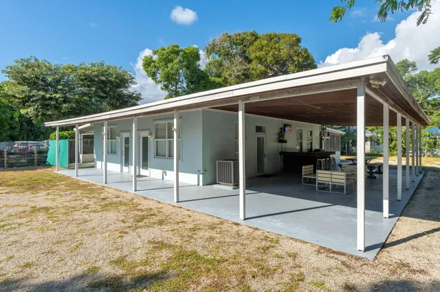 a view of a house with a backyard and balcony