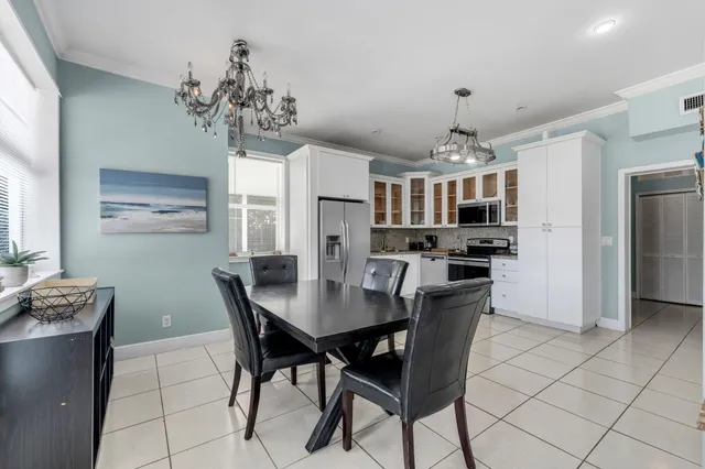 a view of a dining room with furniture and chandelier