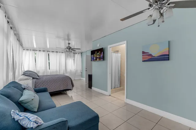 a living room with furniture and a ceiling fan